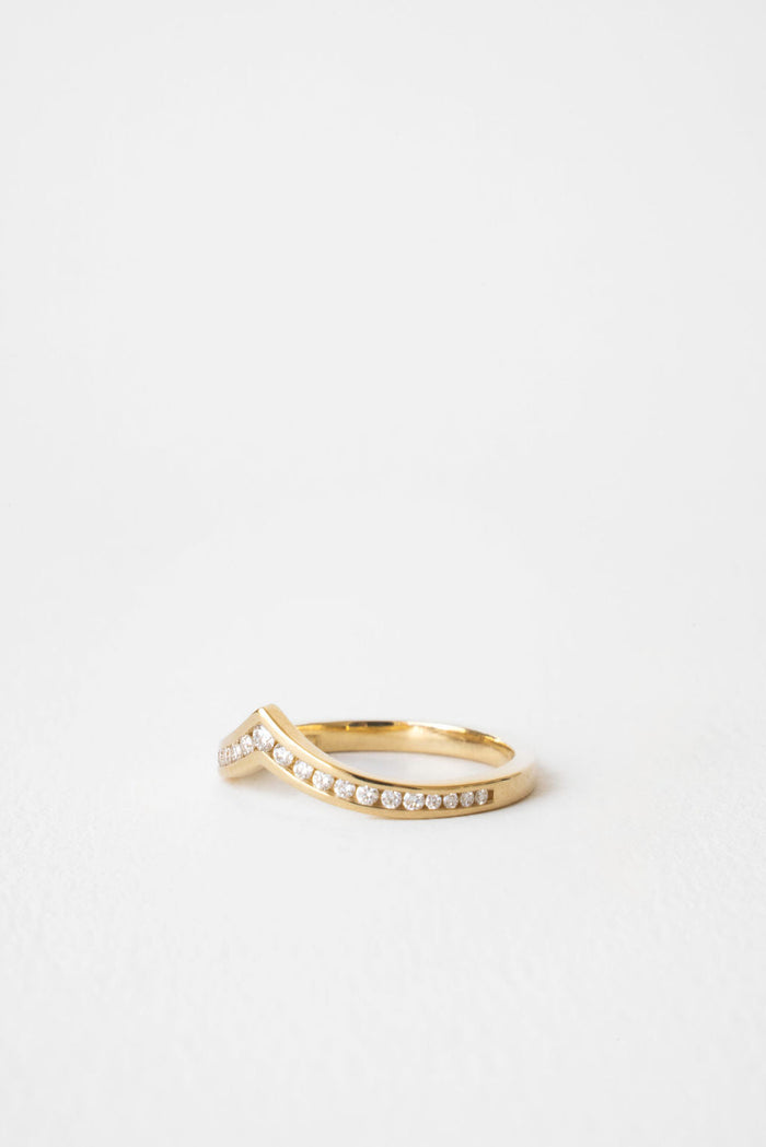 Round curved V shaped channel set moissanite wedding band