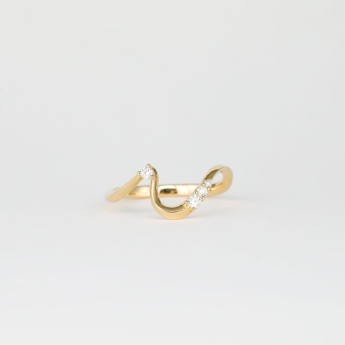 Round moissanite curved wave wedding band in yellow gold, front view