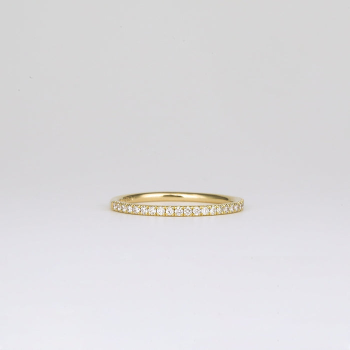 Round moissanite pave half eternity band in yellow gold, front view
