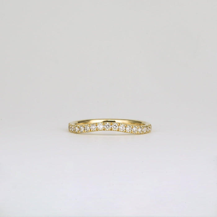 Round moissanite curved pave wedding band in yellow gold, front view