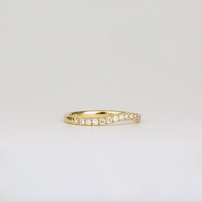Round moissanite curved pave wedding band, angled view