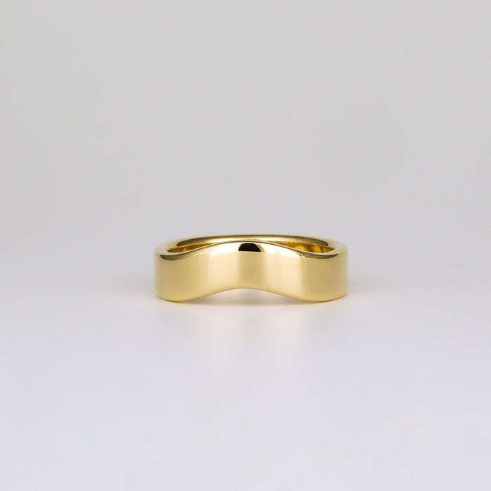 Plain curved contour wedding band in yellow gold, front view