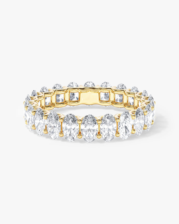 5.00 carat oval moissanite U-prong eternity wedding band in yellow gold