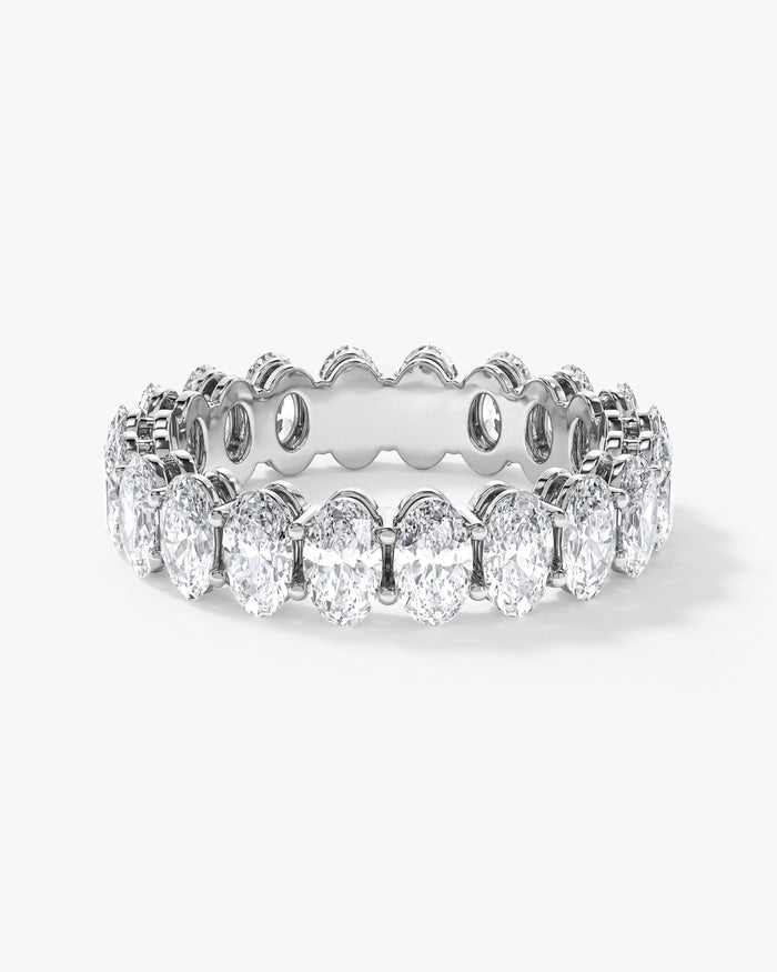 5mm oval moissanite shared prong eternity wedding band in yellow gold