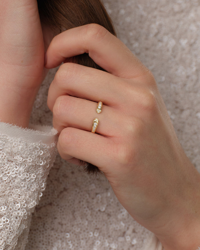 Open moissanite wedding band worn on a model's hand