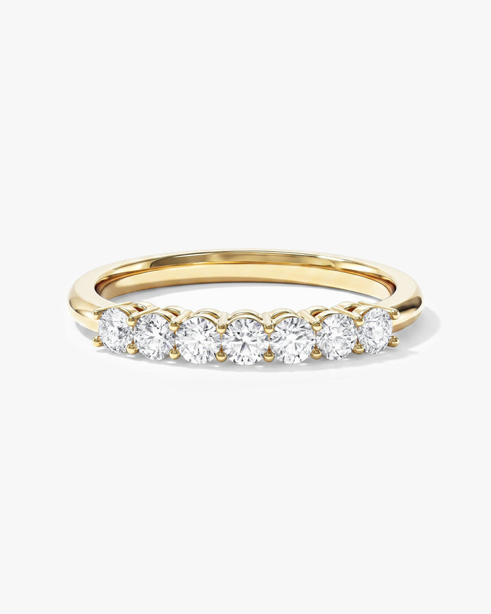Round moissanite classic seven stone anniversary wedding band in yellow gold, front view