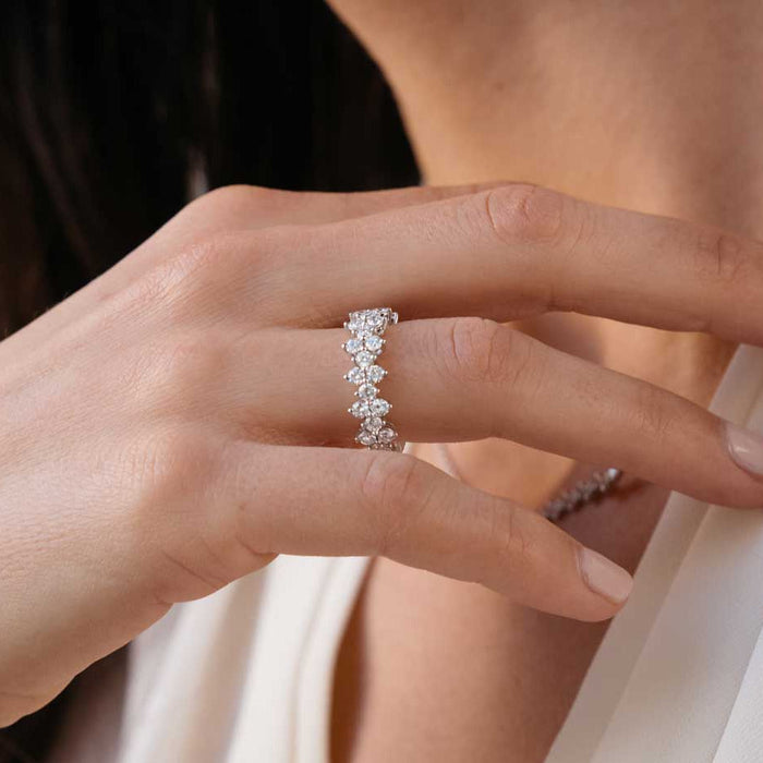 Round moissanite cluster wedding band worn on the finger