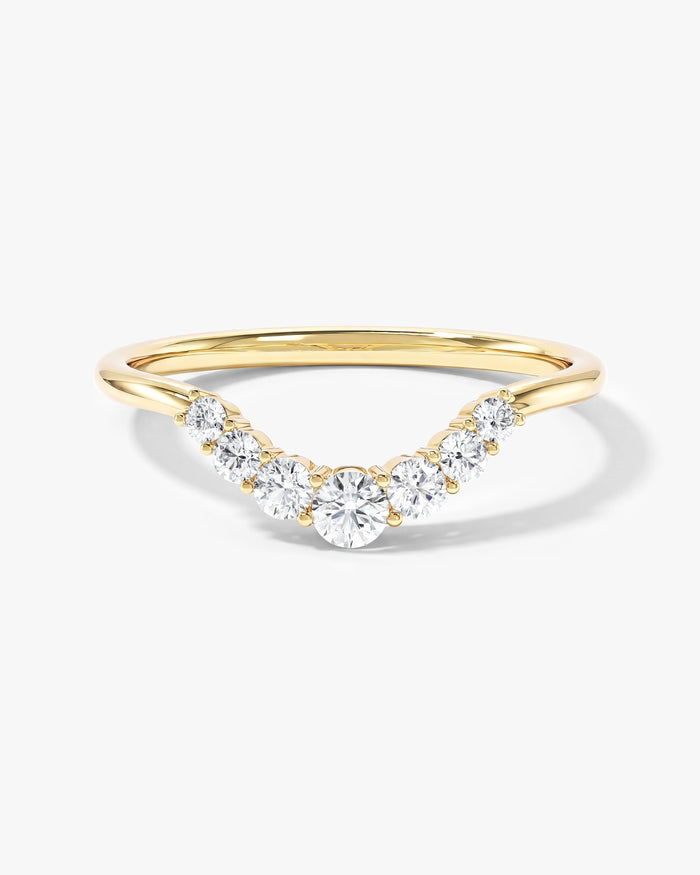 Celestial curved nesting wedding band with graduated round moissanite in yellow gold, front view