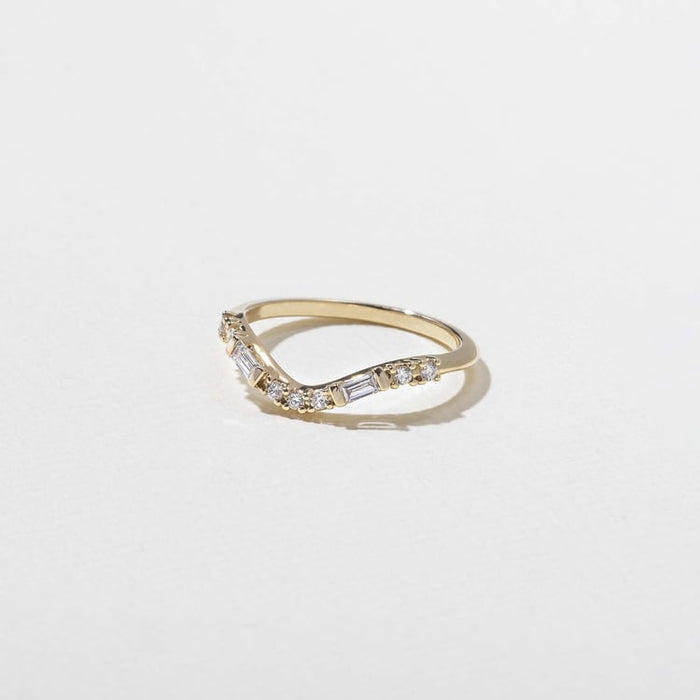 Round and baguette moissanite curved wedding band side view