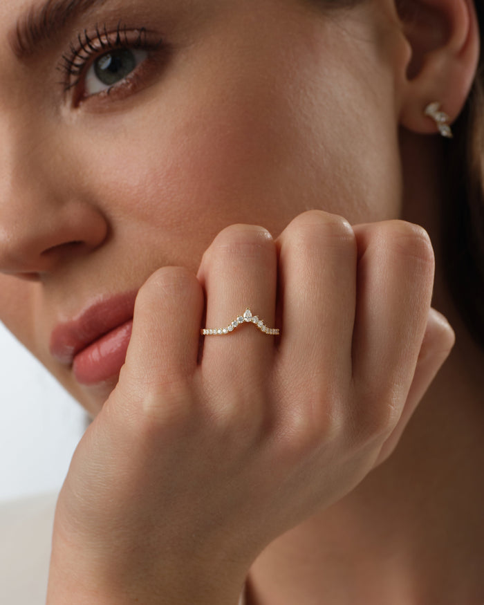 Tiara nesting wedding band worn on a hand, close view
