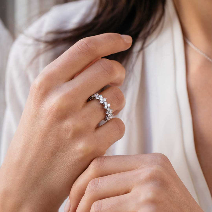 moissanite cluster wedding band with staggered round stones on a hand