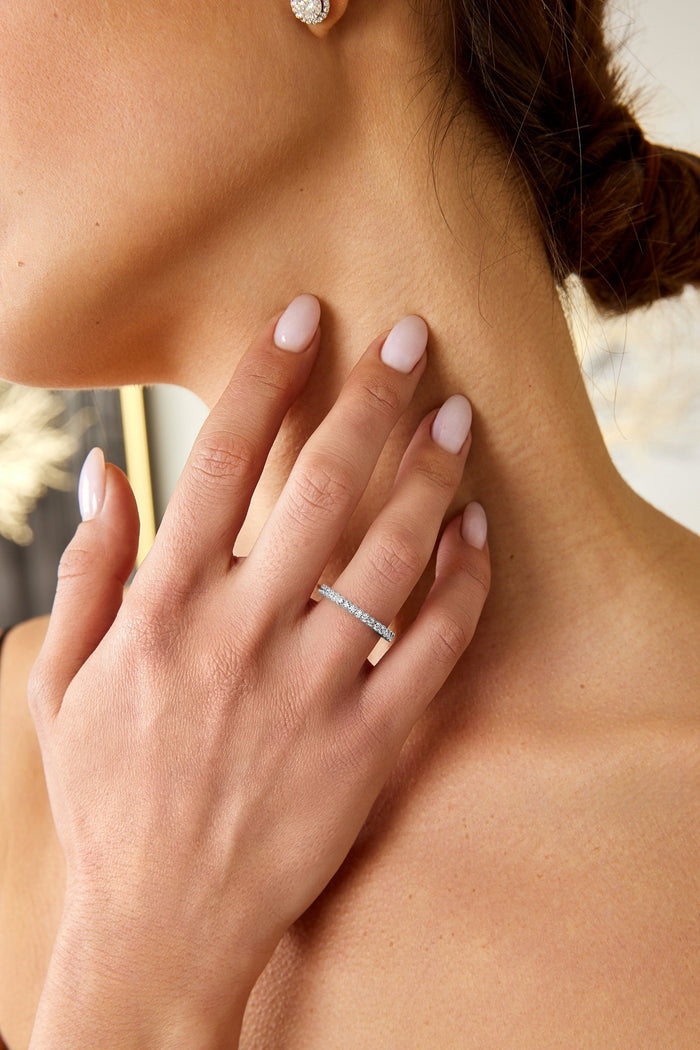 Milgrain half eternity band with moissanites worn on the hand