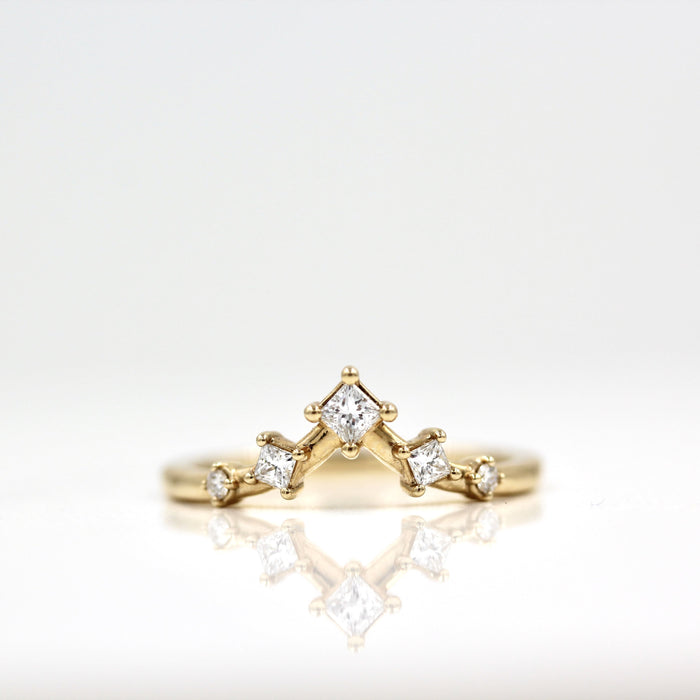 Curved V moissanite wedding band in yellow gold, raised center stone view