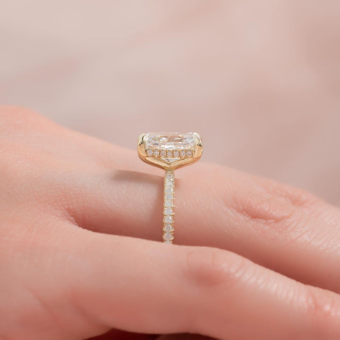 Four claws gripping the cropped corners of the radiant cut diamond