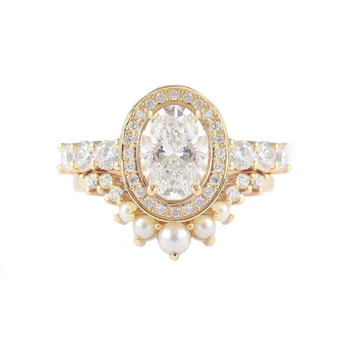 Oval cut lab grown diamond halo engagement ring on a round diamond band in yellow gold