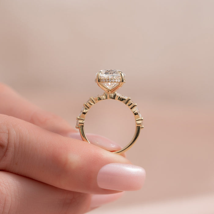 Side view of oval moissanite hidden halo with marquise accents
