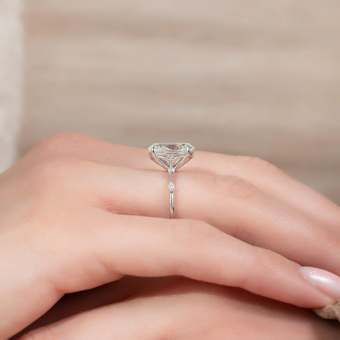 Side view of oval moissanite solitaire with tulip basket