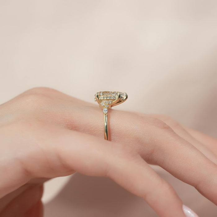 Side view of pear moissanite east west hidden halo ring