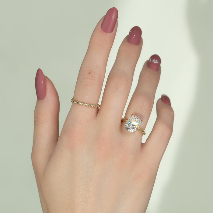 Elongated cushion diamond solitaire with slim yellow gold band