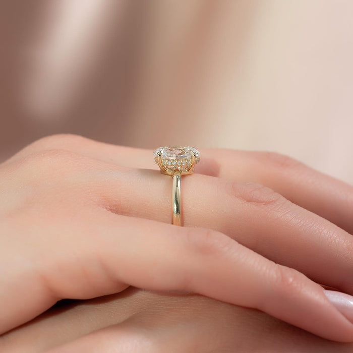 Side view of oval moissanite hidden halo slim band ring