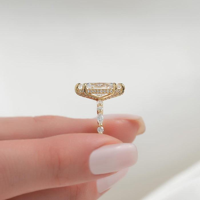 Side view of marquise moissanite hidden halo marquise accent band ring in yellow gold