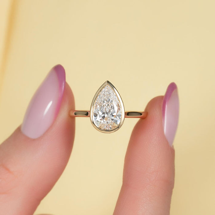 Pear cut lab grown diamond full bezel ring in yellow gold, front view