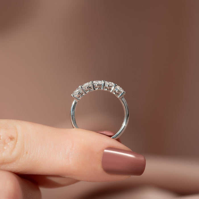 Oval moissanite five stone band ring upright view