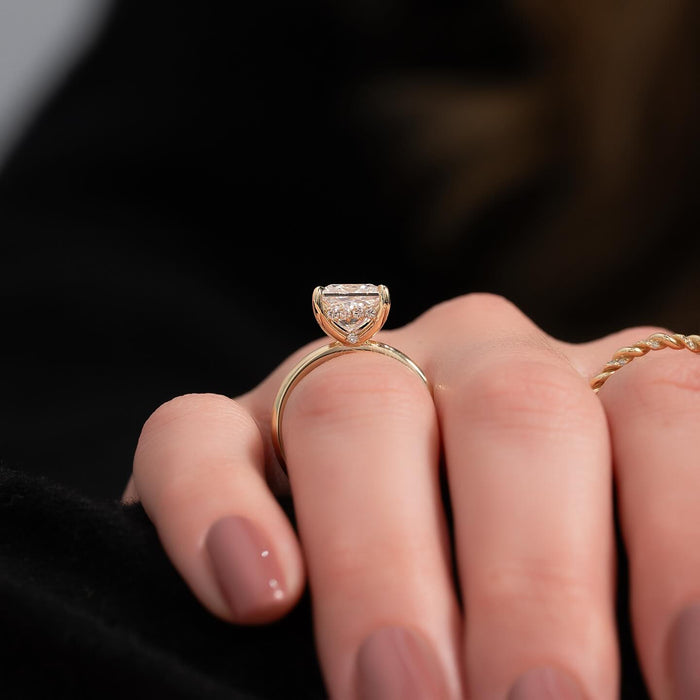Side view of princess moissanite hidden halo thin band ring in yellow gold