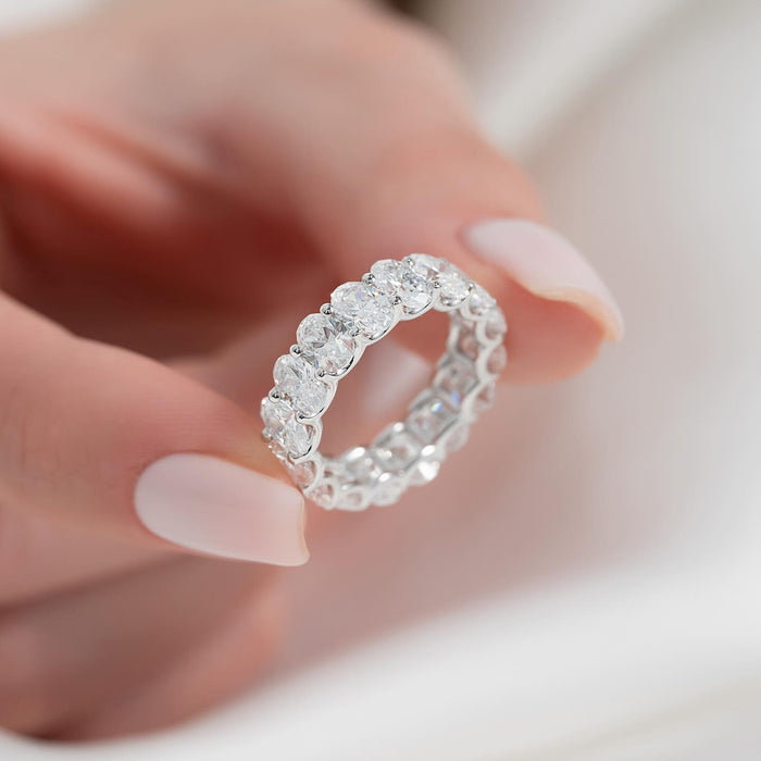 Oval moissanite eternity band worn on finger