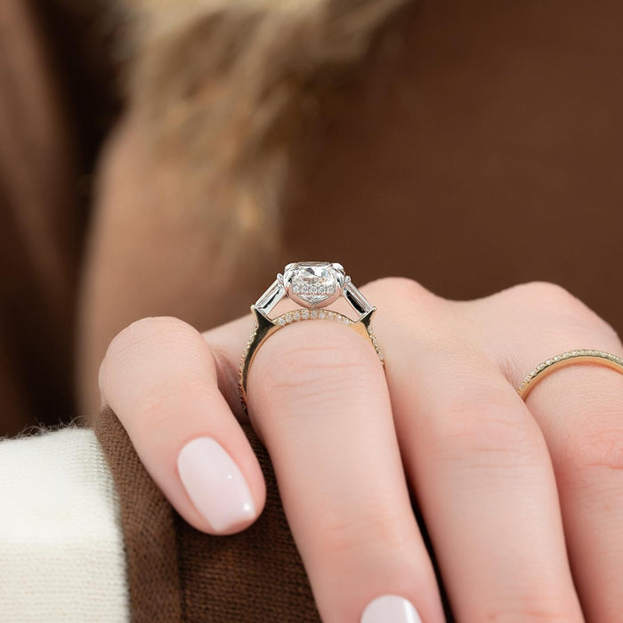 Cushion moissanite three stone ring with tapered baguettes and pave band
