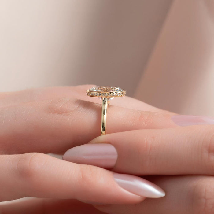 Oval moissanite bezel ring styled on hand
