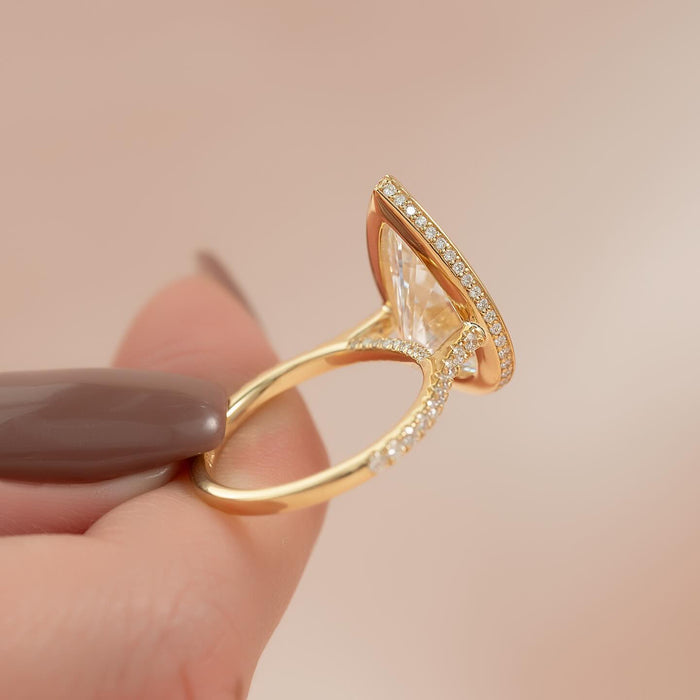 Pear moissanite bezel hidden halo ring profile in yellow gold