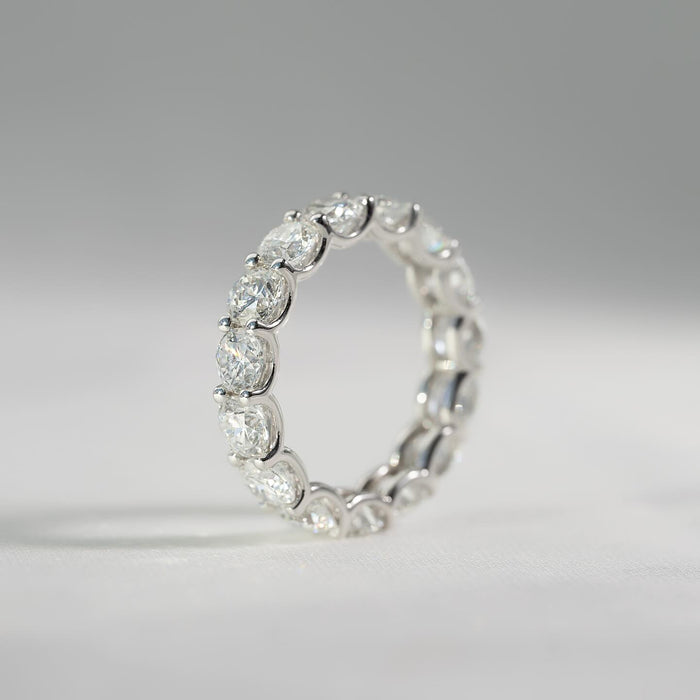 Round moissanite full eternity band ring standing