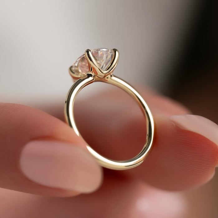 Pear moissanite solitaire ring on hand