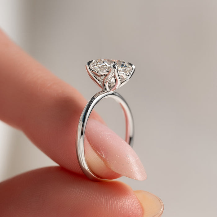 Round moissanite solitaire ring side profile showing floral basket detail