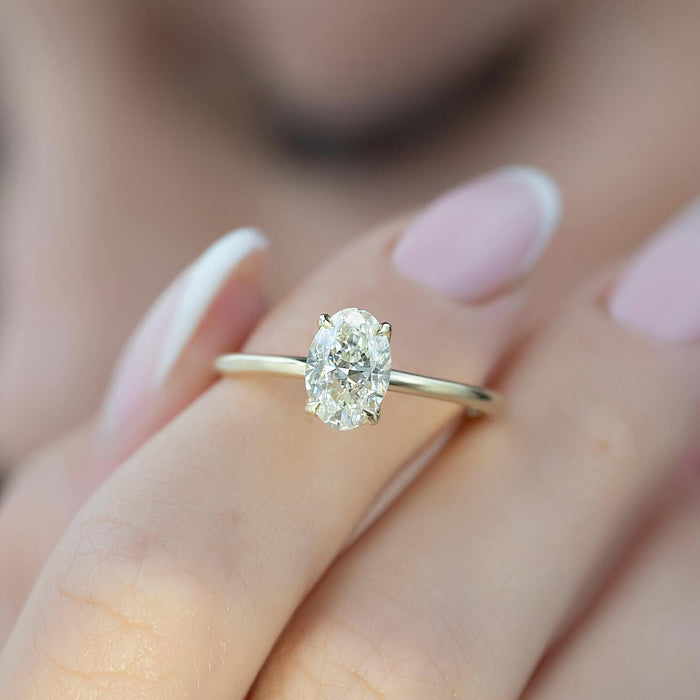 Oval cut lab grown diamond solitaire ring worn on the hand
