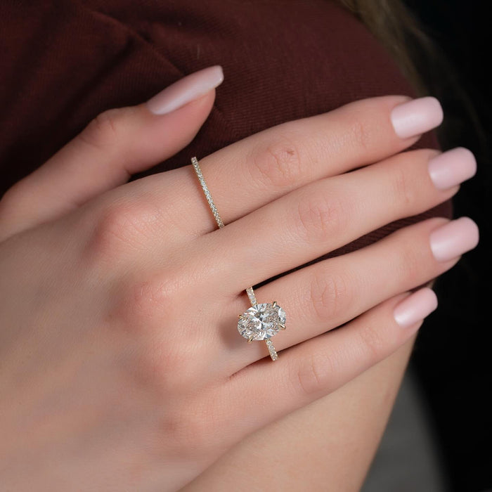 Oval cut lab grown diamond solitaire with full length pave shoulders in yellow gold