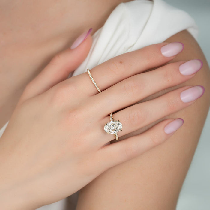 Oval lab grown diamond twisted pave band engagement ring worn on the hand
