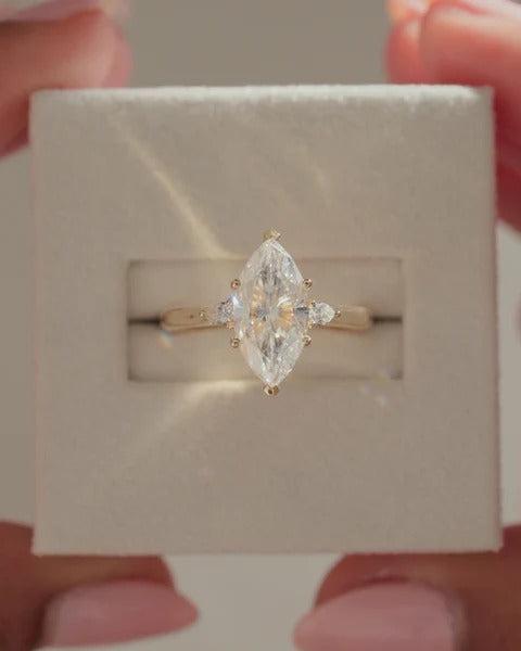 Marquise diamond trilogy ring with pear sides side profile