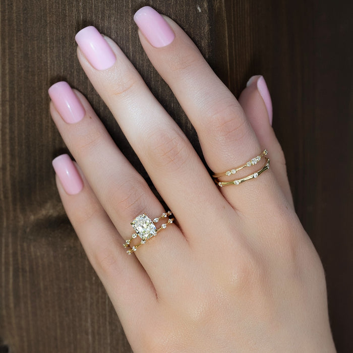Cushion cut lab grown diamond bridal ring set worn on the hand