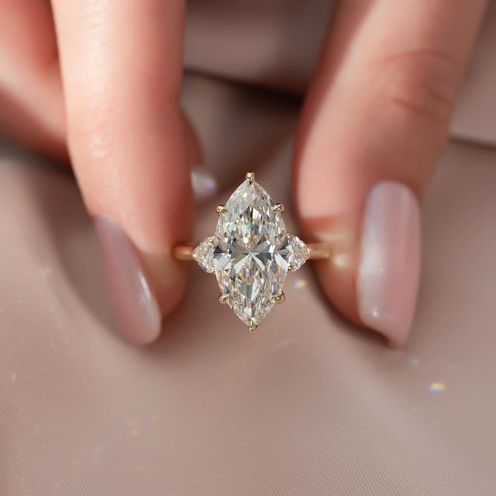 Marquise centre diamond flanked by half moon side stones