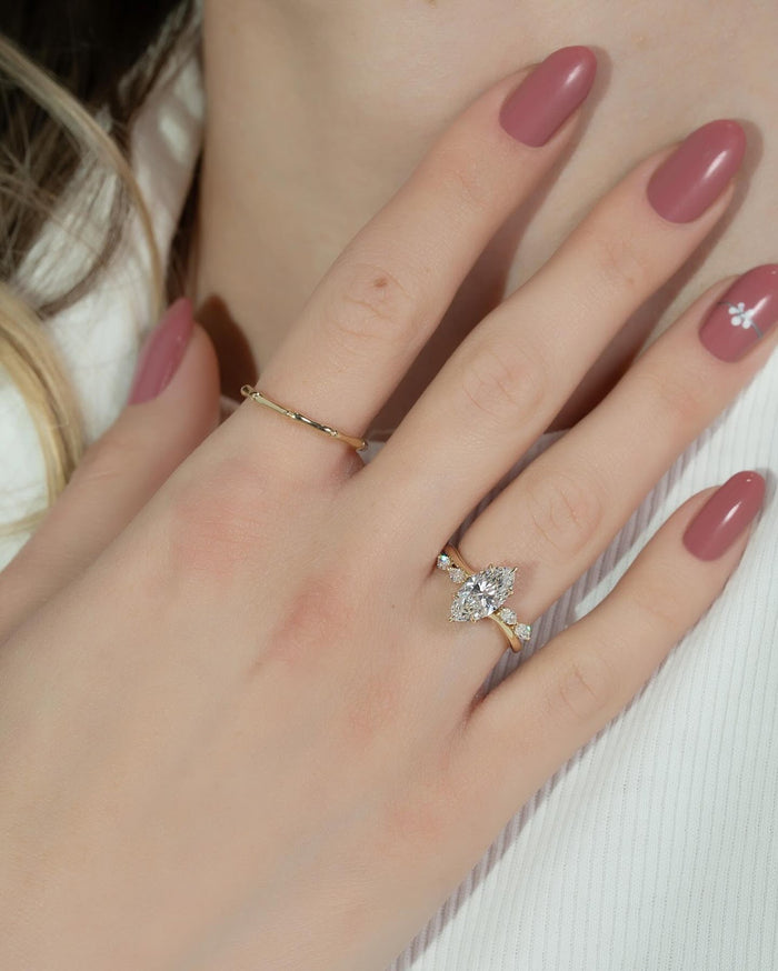 Marquise cut lab grown diamond hidden halo ring in yellow gold worn on the hand