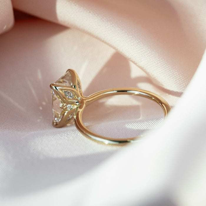 Marquise diamond accents set into the gallery of the elongated radiant ring