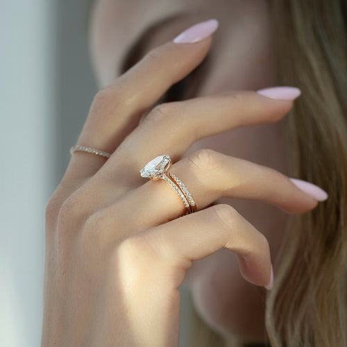 Oval cut lab grown diamond bridal ring set with matching pave bands in rose gold