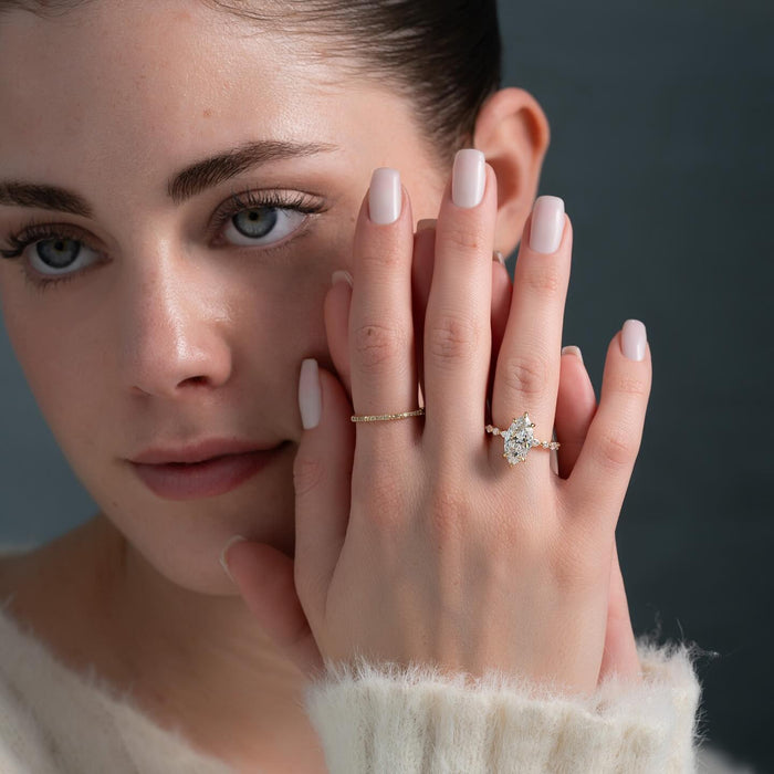 Marquise lab grown diamond engagement ring shown on the hand