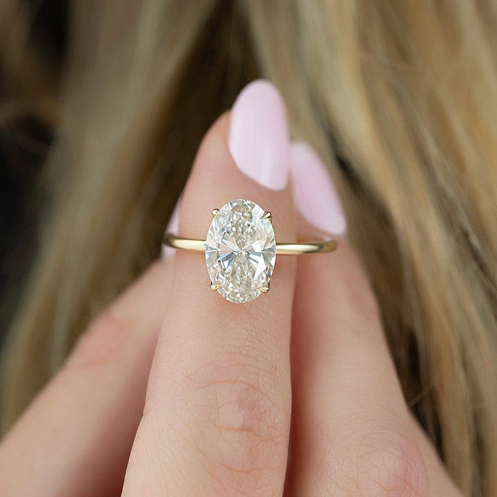 Curved leaves of the lotus claw head beneath the round diamond
