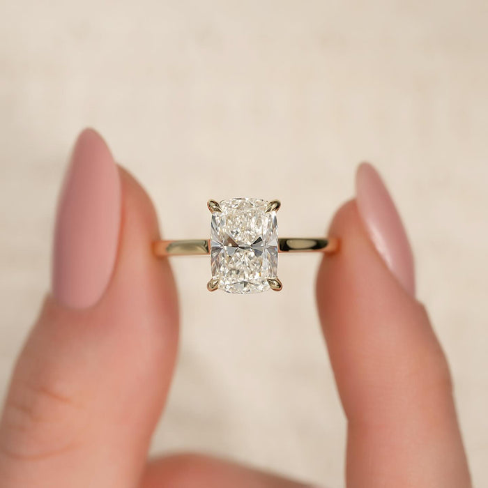 Elongated cushion cut lab grown diamond four claw engagement ring in yellow gold, front view
