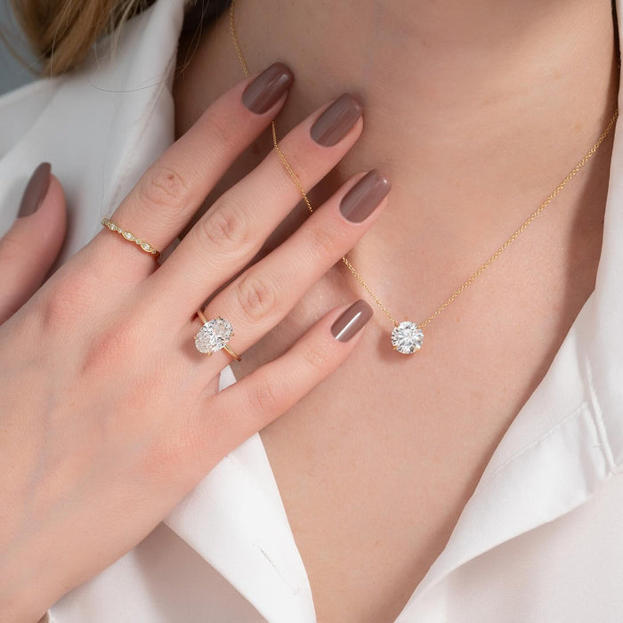 Oval diamond set sideways across the finger on a slim gold band