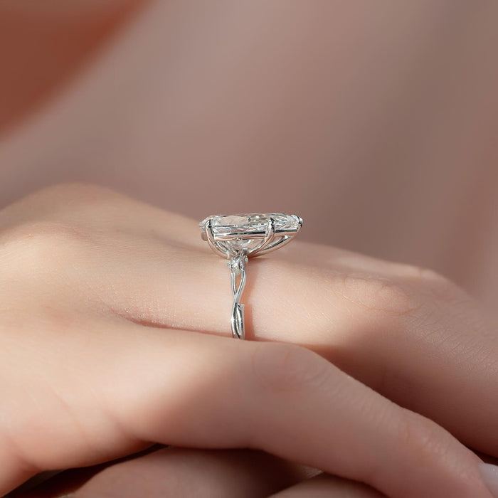 Marquise leaf accents on the shoulders of the pear cut ring