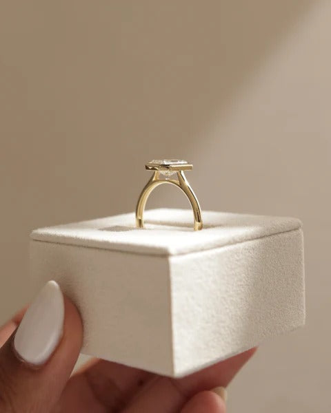 Bezel set radiant diamond raised on an open gallery seen from the side